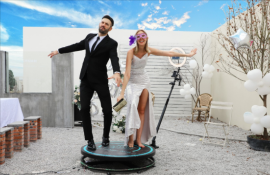 a couple on a 360 degree photobooth rental